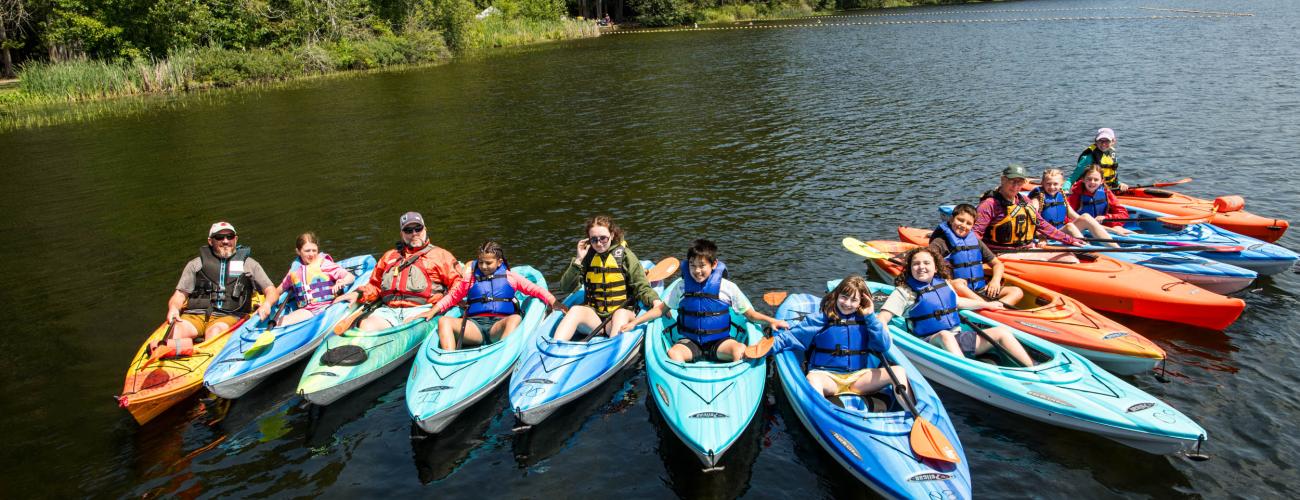 youth participants in a paddle safety course posing for a group photo