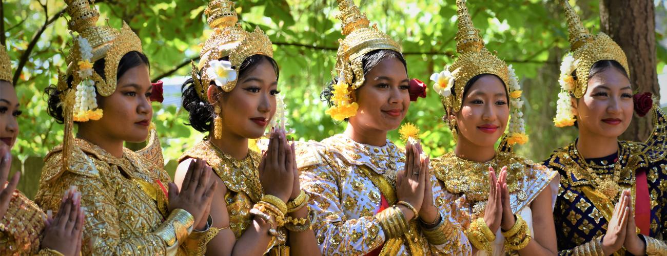 A group of Cambodian women in traditional dress prepare for a dance performance.