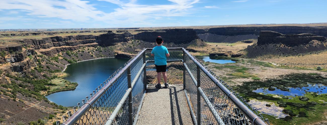 Boy standing on pier lookout at the Dry Falls Visitor Center