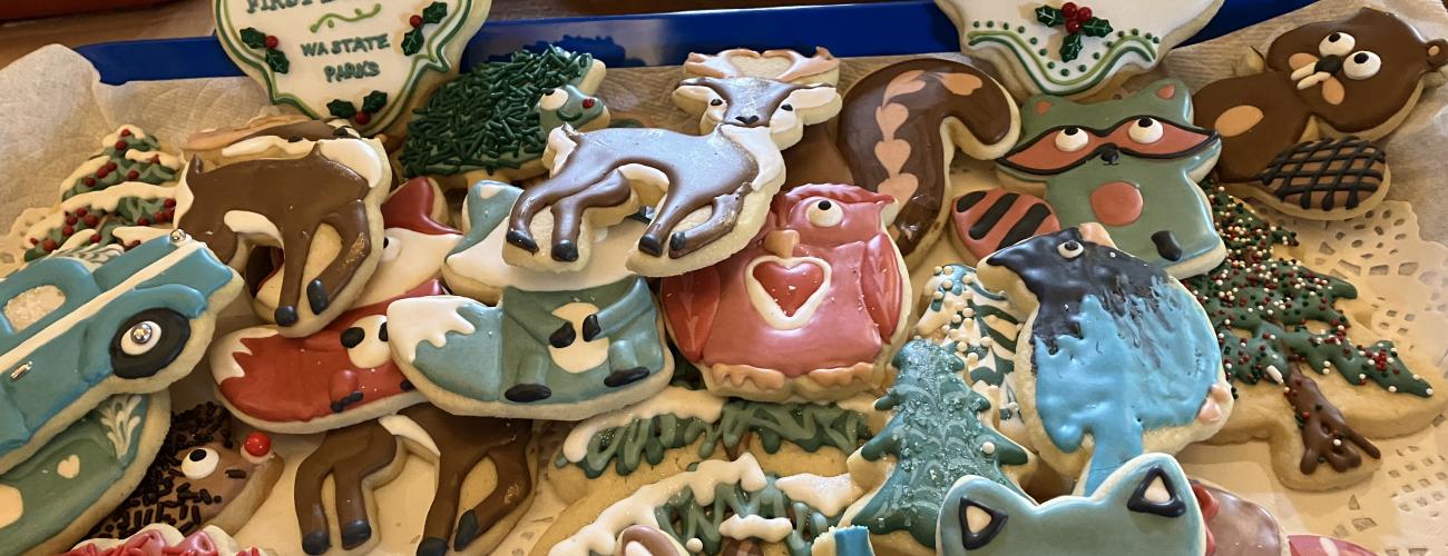 Frosted cookies of wooland creatures piled on a plate