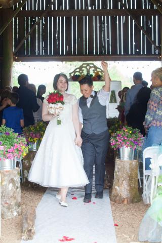 A couple walks up the aisle after getting married