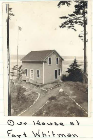 Historic sepia toned photo of a house on the shore with handwritten caption