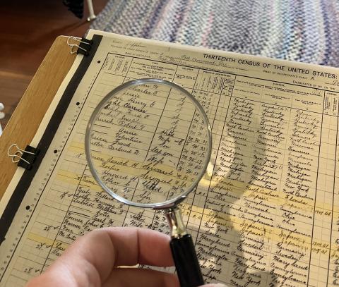 Closeup of census list with magnifying glass