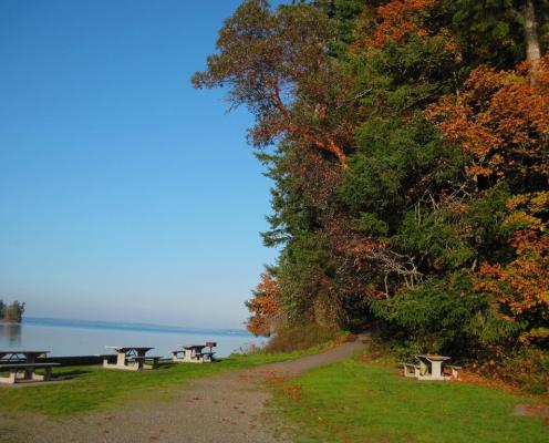 Trail, picnic tables and water at Penrose Point