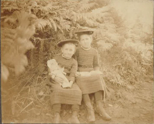 A sepia toned portrait of two children, girls.