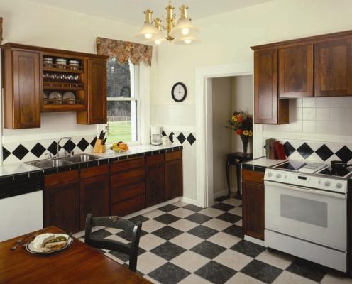 A kitchen with black and white checkered floor and tile in the lightkeeper's house at Cape Disappointment.