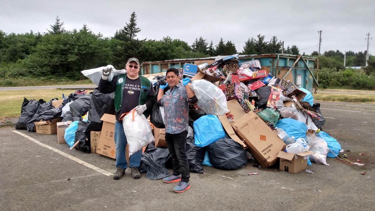 Volunteers carrying garbage to the dumpster
