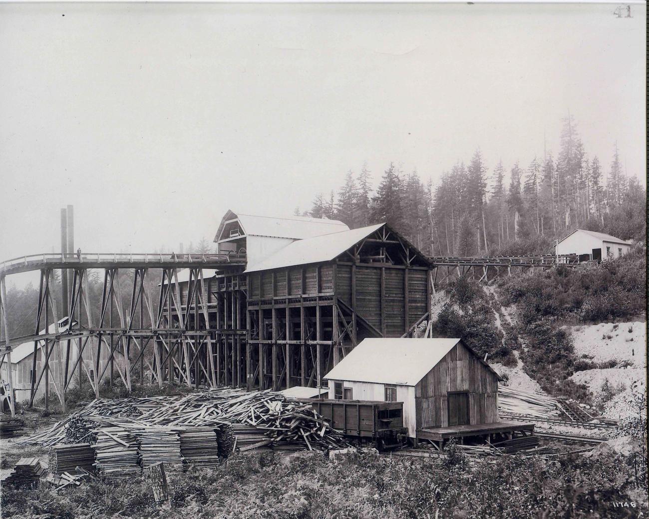 Historic black and white image of the Franklin Townsite shwoing an old logging mill and lumber piles