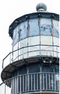 A closeup of the time and weather-worn outside of the lamp room of the Cape Disappointment Lighthouse