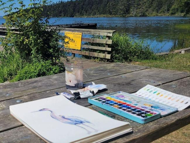 Art in progress laid on a picnic table overlooking Cranberry Lake