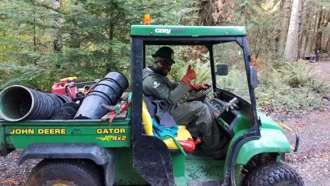 A volunteer drives a John Deere tractor 2