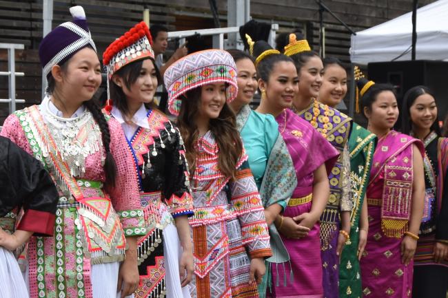 A group of Laotian, Hmong and Khmu women pose in traditional dress.