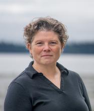 Headshot of Director Diana Dupuis wearing a black shirt.