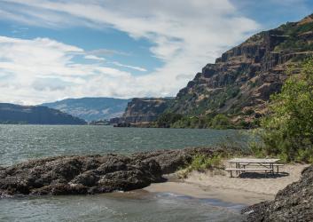 beach shore with picnic table overlooking the lake