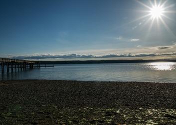 The evening sun glistening on the water at Joemma Beach.