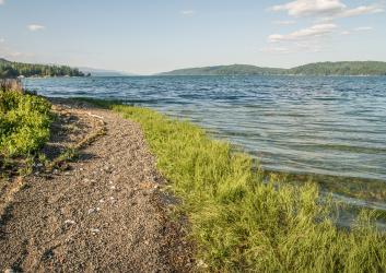 trail leading around a bend of the lake just above the rocky shore