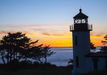 lighthouse with sunset in background