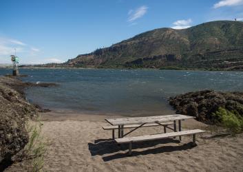 picnic table on beach by river