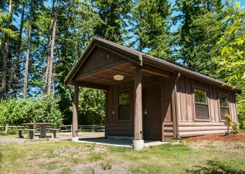 Kitsap Memorial cabin green grass picnic tables forest douglas fir trees