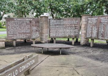 wooden signs with a list of names and text