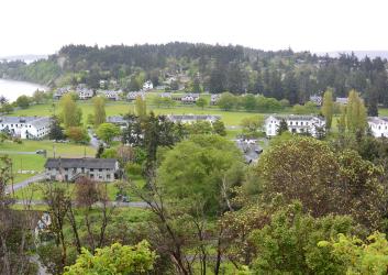A view from a hill of a military fort, a beach and green trees