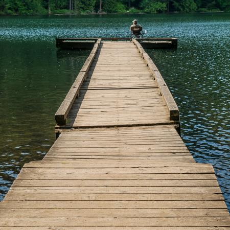 A fisherman sitting on the dock at Battle Ground Lake State Park.