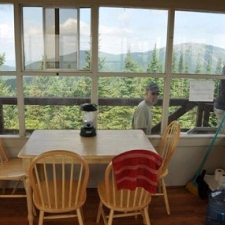 Quartz Mountain Fire Lookout Interior with dining table and outside view