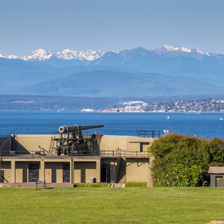 Gun battery look out towards the ocean with snow capped mountains in the distance