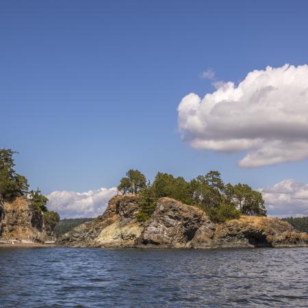 View from the water of the rocky island of Hope Island State Park.