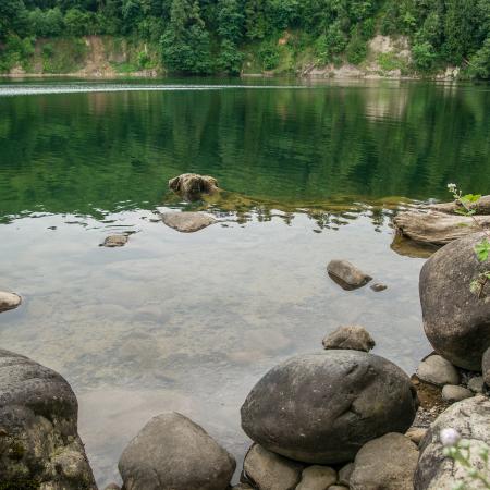 Rocky shoreline with clear smooth lake water