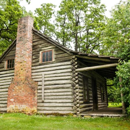 chimney side of log cabin showing porch 