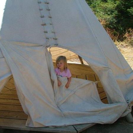 Child playing in teepee
