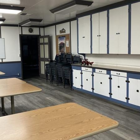 dining hall with tables to the left and cabinets to the right