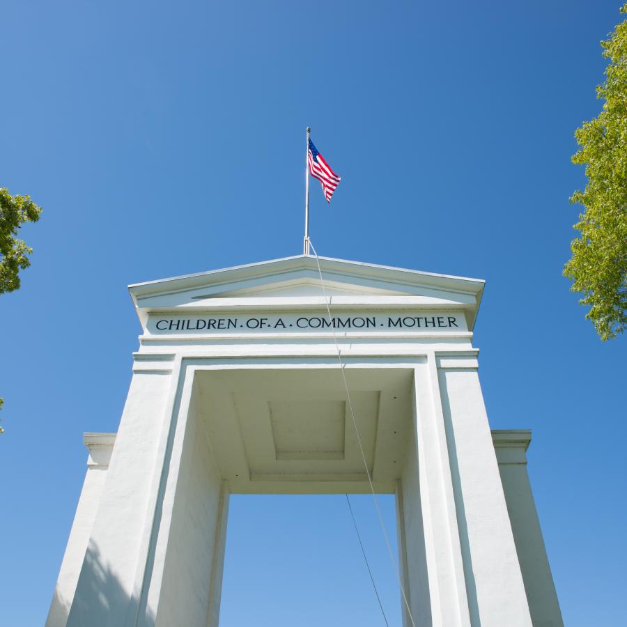 The tall white Peace Arch on a blue sky day 