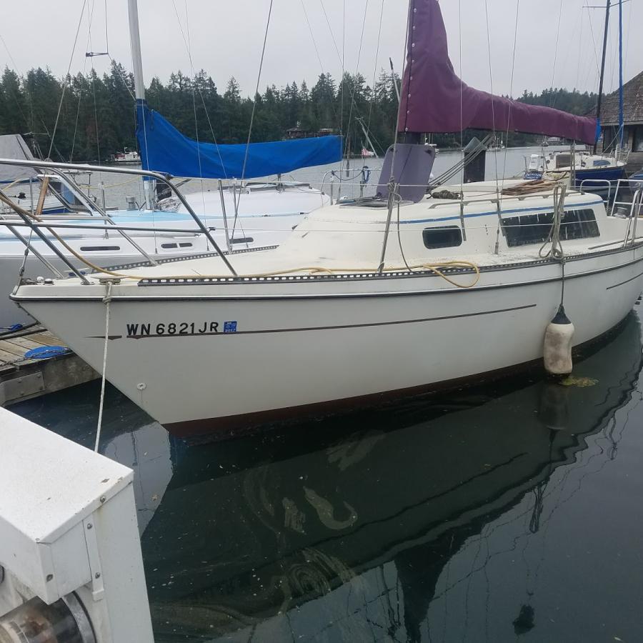 large sailboat moored to dock 