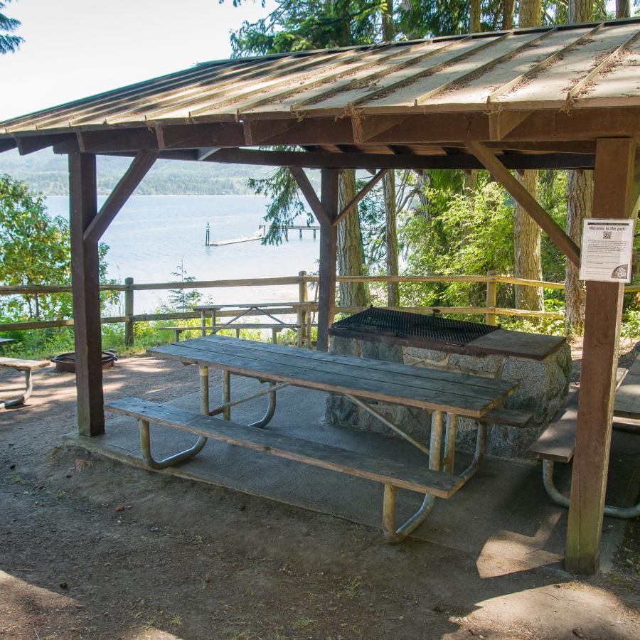 A kitchen shelter with picnic tables at Sequim Bay State Park.