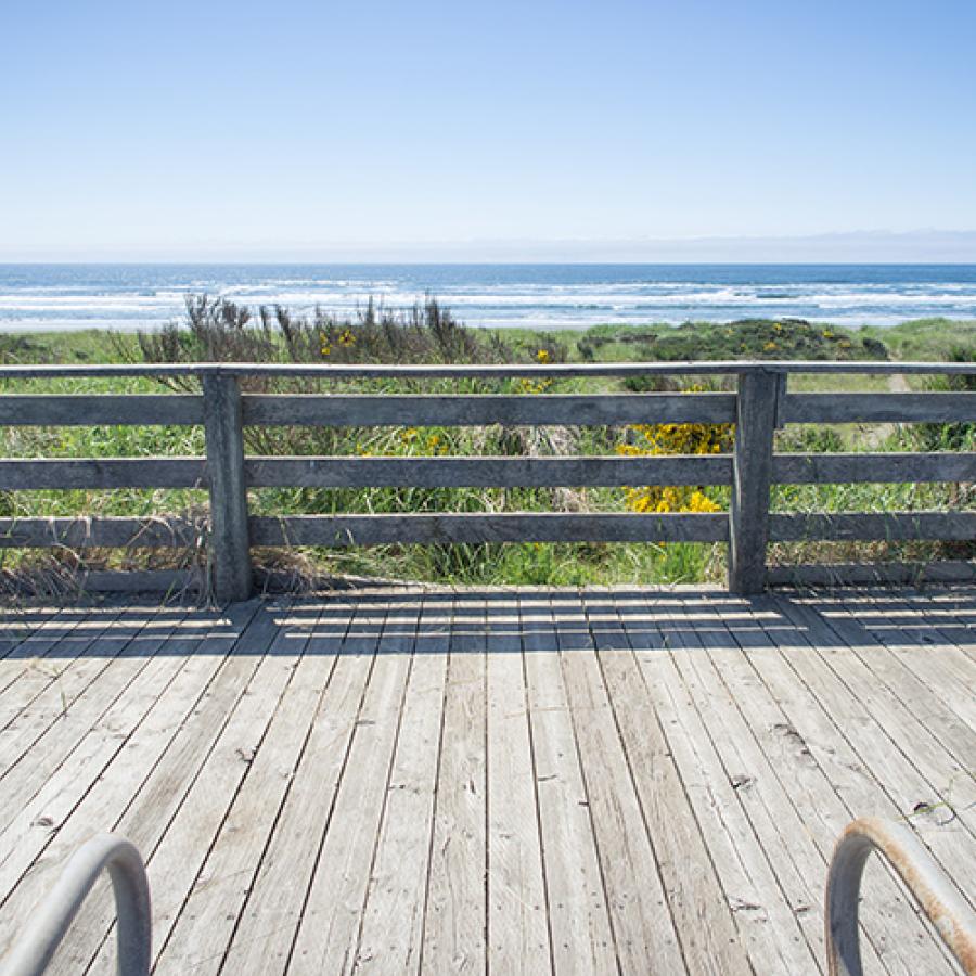 The boardwalk on a sunny day, with the ocean in the background.