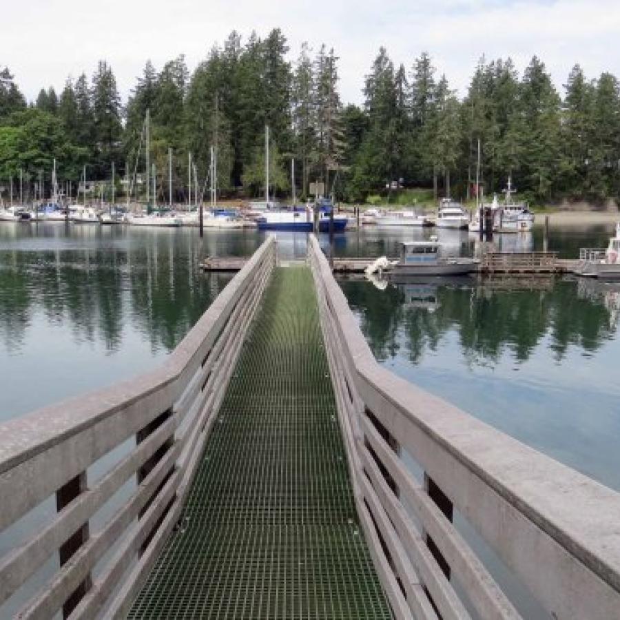 long walkway of dock leading to boat moorage area