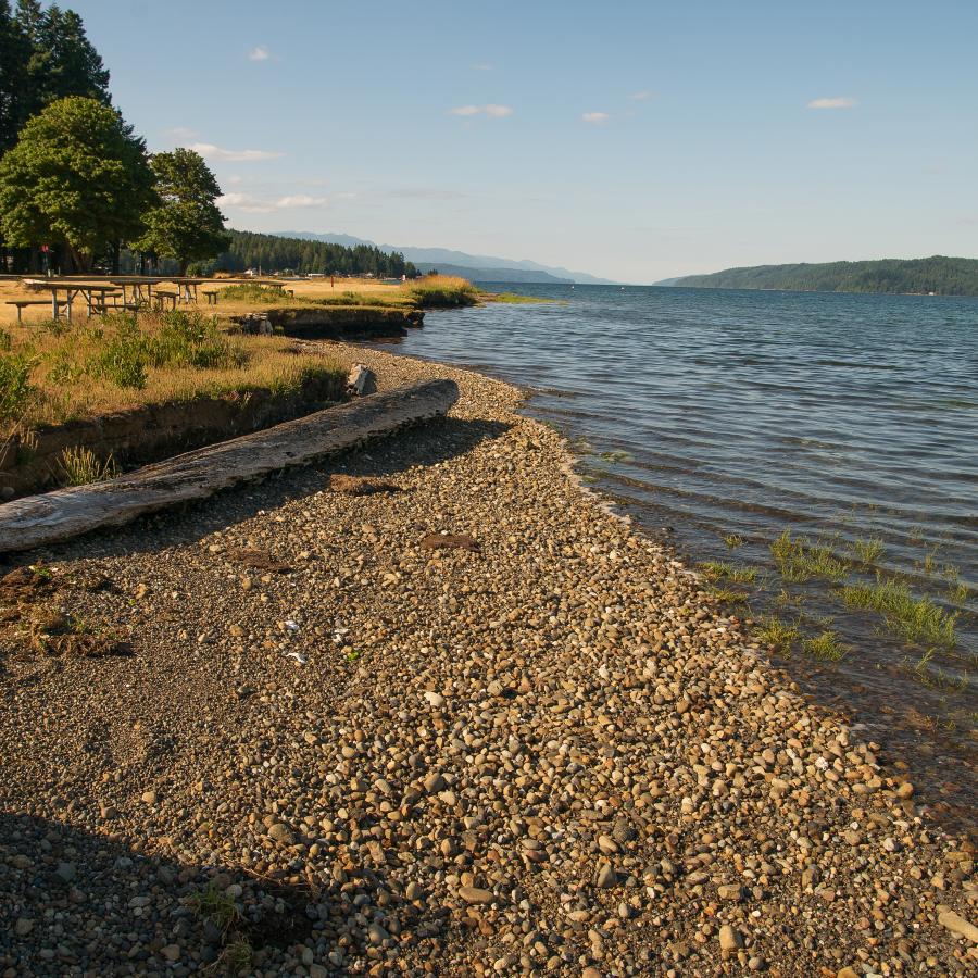 south view of lakeshore of sand and rock