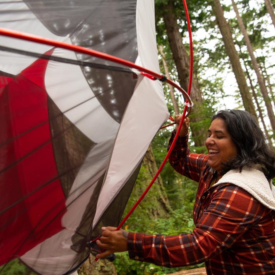 Woman setting up tent.