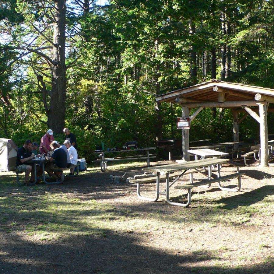 picnic shelter with picnickers at nearby table enjoying their food