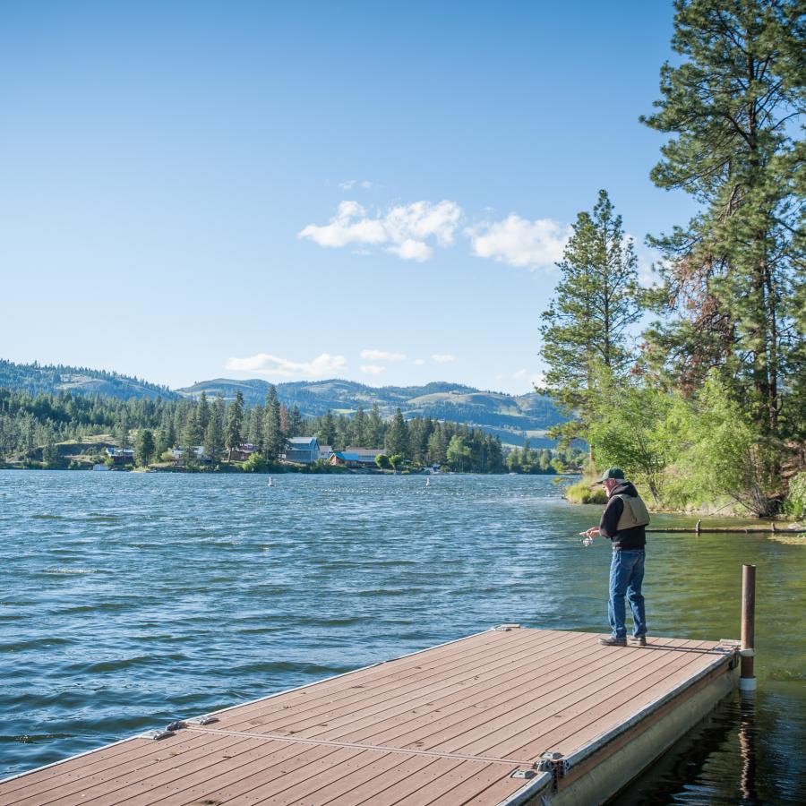 Fisherman on a dock at Curlew Lake.