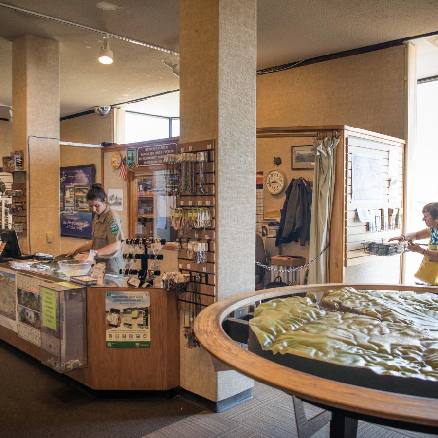 A view inside the interpretive center with a geological map on the right side and merchandise for sale on the left.