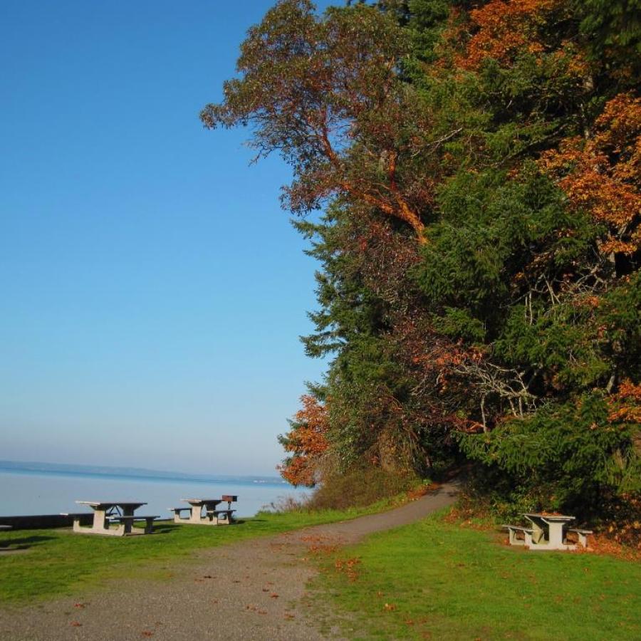 Trail, picnic tables and water at Penrose Point