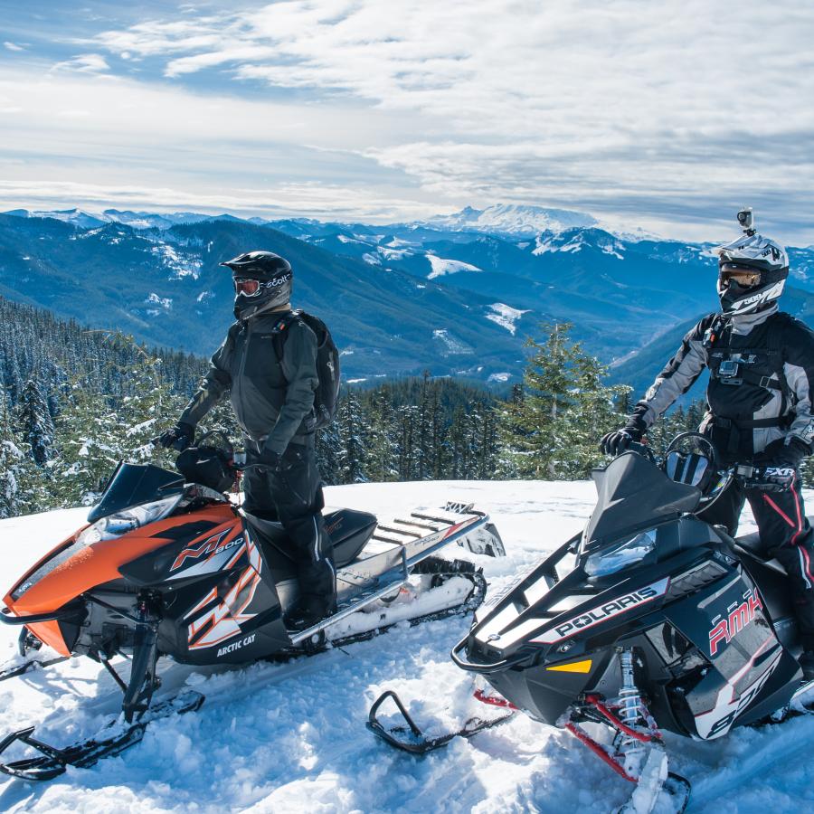 Snowmobiling along ridgeline at Crystal Springs Sno-Park.