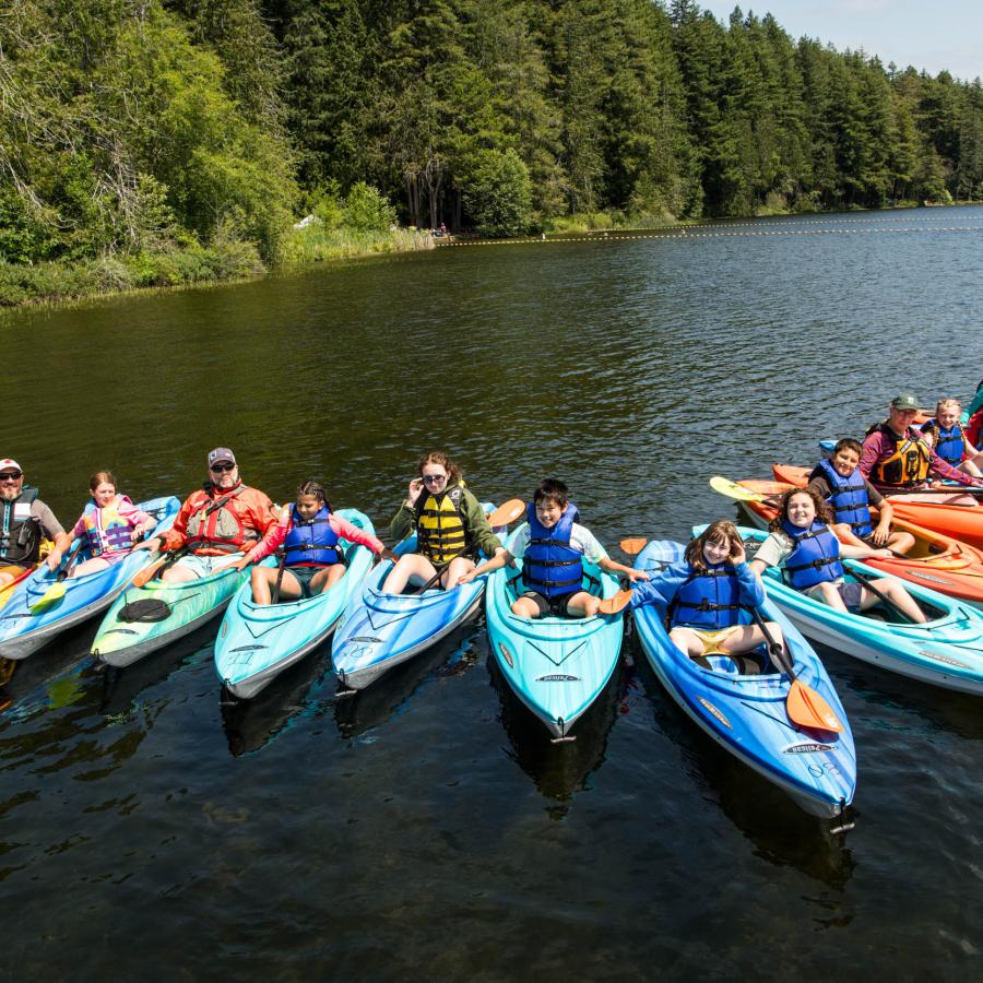 kayak course participants lined up and smiling at the camera