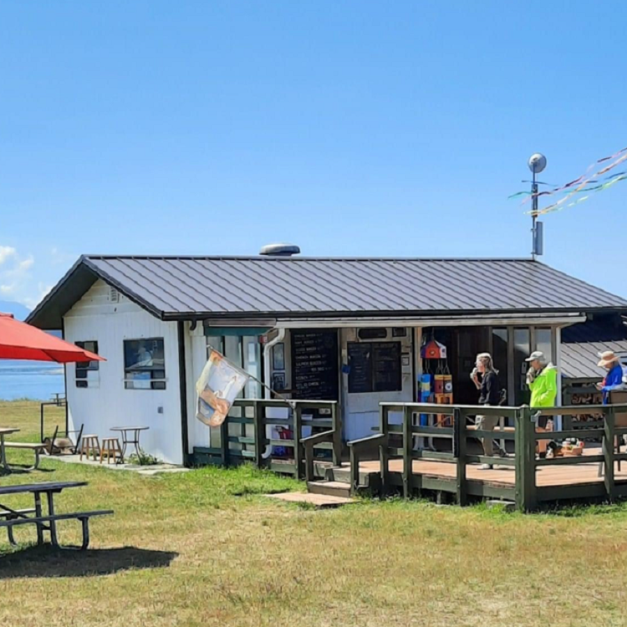 Beachcomber Cafe concession with a view of the sound and large deck with picnic tables