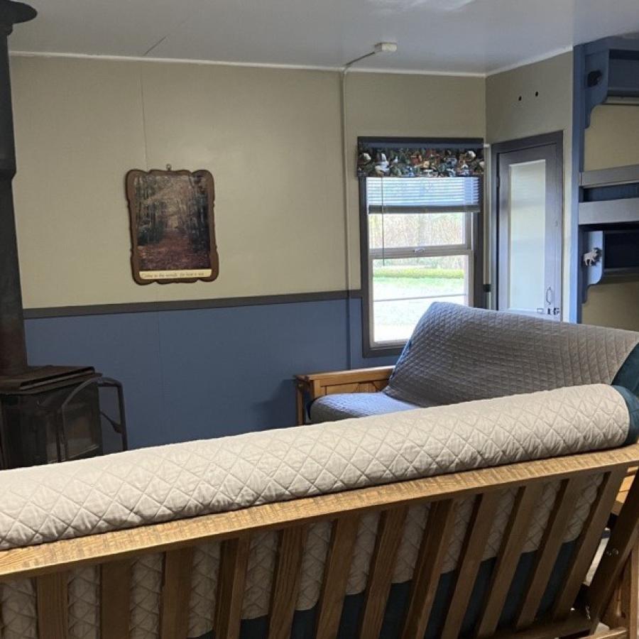 lounge area closeup of woodstove and futons