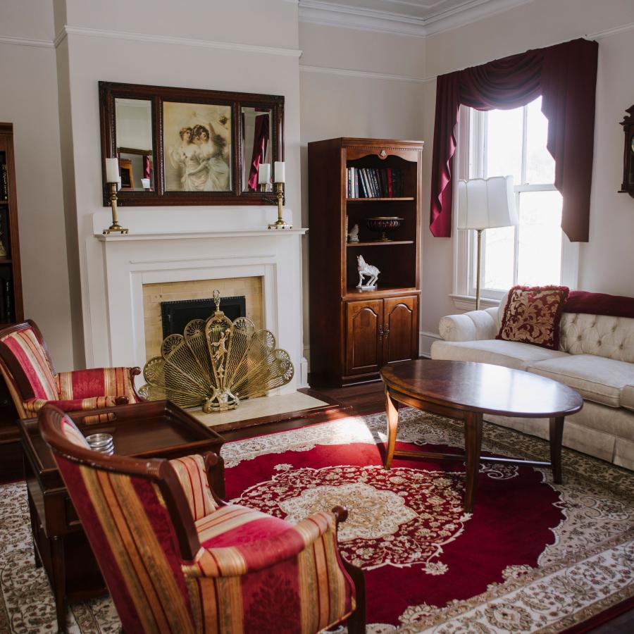 Living Room decorated in Victorian-era furniture with light streaming through the window