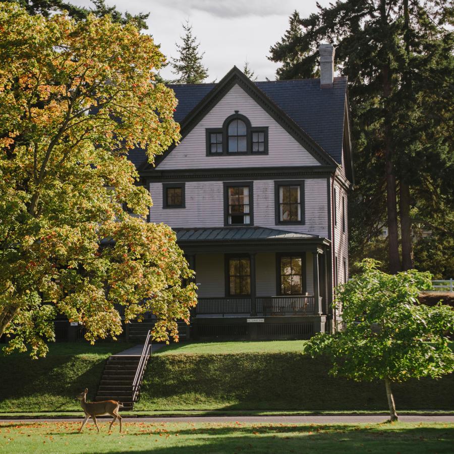 Exterior of historic officer's house surrounded by trees